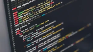 Close-up of a dark computer screen showing colorful syntax-highlighted code