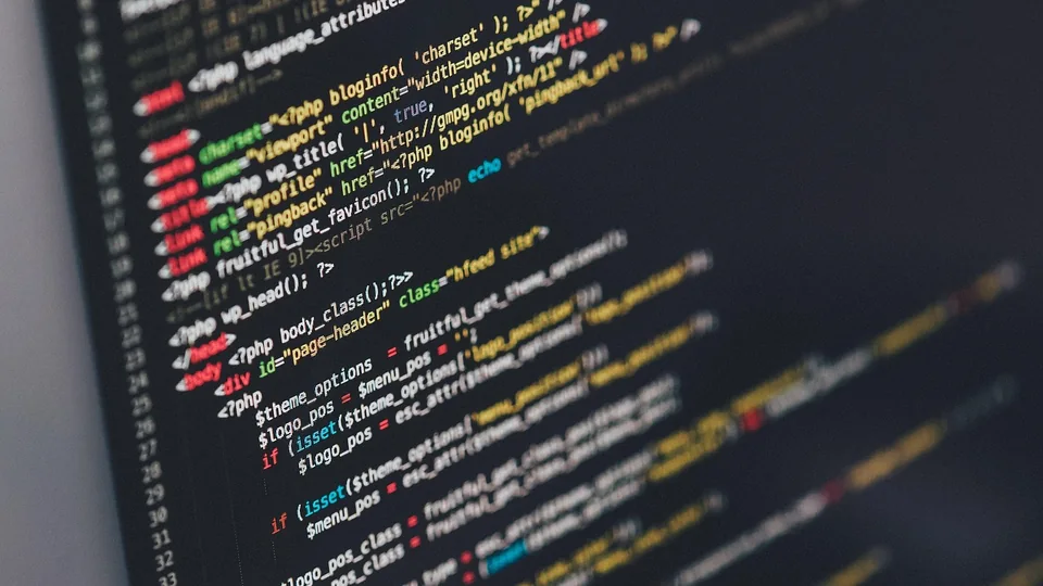 Close-up of a dark computer screen showing colorful syntax-highlighted code