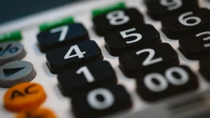 Close-up of calculator keys, a reminder of the extra costs that add up on top of a Shopify plan