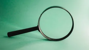 Magnifying glass standing on a green surface